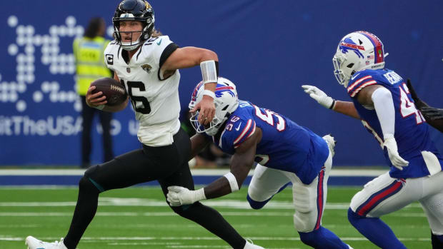 Oct 8, 2023; London, United Kingdom; Jacksonville Jaguars quarterback Trevor Lawrence (16) is pressured by Buffalo Bills defensive end Leonard Floyd (56) and linebacker Terrel Bernard (43) during the second half of an NFL International Series game at Tottenham Hotspur Stadium. Mandatory Credit: Kirby Lee-USA TODAY Sports